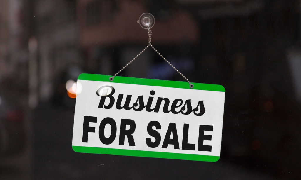 A sign in a window reads "Business for Sale"